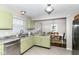 Kitchen featuring granite countertops and stainless steel appliances with view into dining area at 15411 Wandering Way, Noblesville, IN 46060