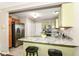 Eat-in kitchen featuring granite countertops, stainless steel appliances, and stylish, light green cabinetry at 15411 Wandering Way, Noblesville, IN 46060