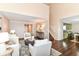 Open-concept living area with wood floors, staircase and an adjoining kitchen at 15411 Wandering Way, Noblesville, IN 46060
