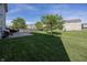 Well-kept backyard featuring a concrete patio, grill, and expansive lawn at 15710 Chapel Park E Dr, Noblesville, IN 46060