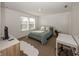Bright bedroom with a double window, a bed with neutral bedding, and a desk with an office chair at 15710 Chapel Park E Dr, Noblesville, IN 46060