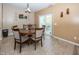 A cozy dining room with tile flooring, a round wood table with six chairs, and a sliding door to the exterior at 15710 Chapel Park E Dr, Noblesville, IN 46060