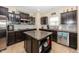 Well-lit kitchen with an island, stainless steel appliances, granite countertops and dark wood cabinetry at 15710 Chapel Park E Dr, Noblesville, IN 46060