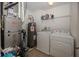 Well-lit laundry room features a washer, dryer, water heater, and storage at 15710 Chapel Park E Dr, Noblesville, IN 46060