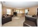 Spacious living room with neutral walls, a large sectional sofa, and an open view to other rooms at 15710 Chapel Park E Dr, Noblesville, IN 46060