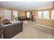 Upstairs living room featuring a sectional sofa, neutral walls, and view of downstairs at 15710 Chapel Park E Dr, Noblesville, IN 46060