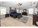 Spacious main bedroom with tray ceiling, dark wood furniture, and neutral carpet at 15710 Chapel Park E Dr, Noblesville, IN 46060