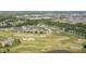 Aerial view of a residential neighborhood with golf course, ponds, and mature trees at 16502 Grand Cypress Dr, Noblesville, IN 46060