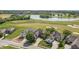 Aerial view showcasing luxury homes situated around a golf course and a serene lake at 16502 Grand Cypress Dr, Noblesville, IN 46060
