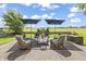 Inviting backyard patio with seating, umbrellas, and golf course views at 16502 Grand Cypress Dr, Noblesville, IN 46060