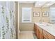 Well-lit bathroom featuring a vanity with a white countertop and a shower with a decorative shower curtain at 16502 Grand Cypress Dr, Noblesville, IN 46060