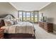 Cozy bedroom showcasing a large window with a picturesque outdoor view at 16502 Grand Cypress Dr, Noblesville, IN 46060