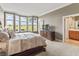 Comfortable bedroom with a large bed, dresser, and a window offering natural light at 16502 Grand Cypress Dr, Noblesville, IN 46060