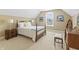 Cozy bedroom with a decorative window, matching bedside tables and lamps, and plush carpeting at 16502 Grand Cypress Dr, Noblesville, IN 46060