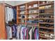 Organized walk-in closet with built-in shelving, hanging rods, and ample storage space at 16502 Grand Cypress Dr, Noblesville, IN 46060