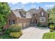Charming brick home with a three-car garage and manicured lawn at 16502 Grand Cypress Dr, Noblesville, IN 46060