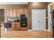 Kitchen with wood cabinets, black appliances, granite countertops and desk space at 16502 Grand Cypress Dr, Noblesville, IN 46060