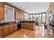 Well-lit kitchen featuring wood cabinets, granite countertops, and a view of the breakfast nook at 16502 Grand Cypress Dr, Noblesville, IN 46060