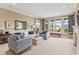 Inviting living room with large windows offering scenic views, fireplace, and neutral decor at 16502 Grand Cypress Dr, Noblesville, IN 46060