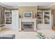 Cozy living room with a fireplace, built-in shelving, and serene decor at 16502 Grand Cypress Dr, Noblesville, IN 46060