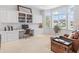 Well-lit office featuring custom white cabinetry, desk space, bay window, and sitting area at 16502 Grand Cypress Dr, Noblesville, IN 46060