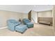 Cozy sitting area with carpet, neutral paint, and comfortable blue armchairs at 16502 Grand Cypress Dr, Noblesville, IN 46060