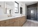 Bathroom featuring a double vanity, black trimmed window, and walk-in shower with unique tiling at 1664 Carrollton Rail Dr, Westfield, IN 46074