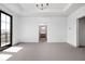 Spacious Primary bedroom with tray ceiling, plush carpeting, and large windows offering plenty of natural light at 1664 Carrollton Rail Dr, Westfield, IN 46074