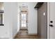 Inviting entryway featuring a coat rack with hooks, modern door, and wood-look flooring at 1664 Carrollton Rail Dr, Westfield, IN 46074
