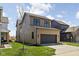 Two-story home with brown siding, dark windows, and a dark garage door on a well-kept lawn at 1664 Carrollton Rail Dr, Westfield, IN 46074