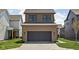 Two-story home with brown siding, dark windows, and a dark garage door at 1664 Carrollton Rail Dr, Westfield, IN 46074