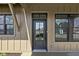 Close up of front door with side windows and the reflection of neighborhood buildings at 1664 Carrollton Rail Dr, Westfield, IN 46074