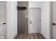 Hallway featuring a coat rack with hooks, modern door, and wood-look flooring at 1664 Carrollton Rail Dr, Westfield, IN 46074