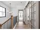 Hallway with decorative lighting, view of kitchen, and stairs with iron railing at 1664 Carrollton Rail Dr, Westfield, IN 46074