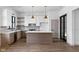 Open concept kitchen with white countertops, designer lighting and decorative backsplash at 1664 Carrollton Rail Dr, Westfield, IN 46074