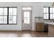 Kitchen with stainless steel appliances, wood floors and natural light from windows and doors at 1664 Carrollton Rail Dr, Westfield, IN 46074