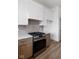 Kitchen featuring stainless steel oven range, white cabinets, and decorative backsplash at 1664 Carrollton Rail Dr, Westfield, IN 46074