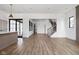 Spacious living room with hardwood floors and an open floor plan to the kitchen and access to outdoor covered patio at 1664 Carrollton Rail Dr, Westfield, IN 46074