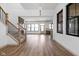 Expansive living room with hardwood flooring, modern staircase, and bright windows showcasing an open floor plan at 1664 Carrollton Rail Dr, Westfield, IN 46074