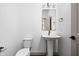 Elegant powder room with a pedestal sink, gold fixtures, and modern finishes, offering a stylish and functional space at 1664 Carrollton Rail Dr, Westfield, IN 46074