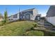 This backyard features a blue house with a chimney, white fencing, trampoline, and garden beds at 1664 Woodside Cir, Franklin, IN 46131