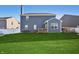 This backyard has a blue house with a chimney, white fencing, a lush lawn, and an outdoor seating area at 1664 Woodside Cir, Franklin, IN 46131