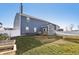 A spacious backyard features a blue house with a chimney, white fencing, trampoline and lawn at 1664 Woodside Cir, Franklin, IN 46131