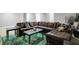 A basement living area, showing a large comfortable leather sectional and a distinctive green patterned area rug at 1664 Woodside Cir, Franklin, IN 46131
