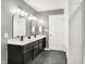 Elegant bathroom with dual sinks, a large mirror, and stylish black and white accents at 1664 Woodside Cir, Franklin, IN 46131