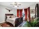 A beautifully decorated bedroom with a statement bed, red curtains, and ample natural light at 1664 Woodside Cir, Franklin, IN 46131