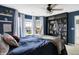 Stylish bedroom with dark blue walls, bookshelves, and a hammock chair at 1664 Woodside Cir, Franklin, IN 46131