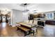 Dining area featuring a modern table and bench seating, open to the kitchen at 1664 Woodside Cir, Franklin, IN 46131