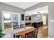 Dining area with hardwood floors and sliding doors leading to deck offers a great view into the living and kitchen areas at 1664 Woodside Cir, Franklin, IN 46131