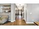 Inviting hallway with hardwood floors and decorative shelves at 1664 Woodside Cir, Franklin, IN 46131